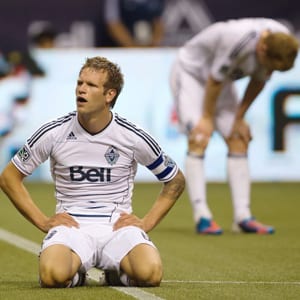 Vancouver Whitecaps FC players Jay Demerit and Barry Robson are shown on the pitch at BC Place.
