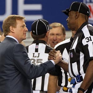 NFL Commissioner Roger Goodell shakes hands with referee Chad Brown at the 2011 Super Bowl.