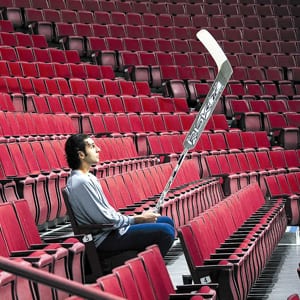 Roberto Luongo looks on from the stands at General Motors Place.