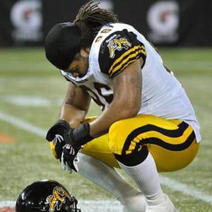 Hamilton Tiger-Cats defensive tackle Terrence Moore pauses on the field after his team's loss to the Toronto Argonauts during their CFL game in Toronto November 1, 2012.